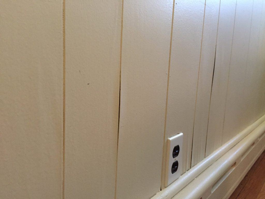 How do you prepare wood paneling for painting?