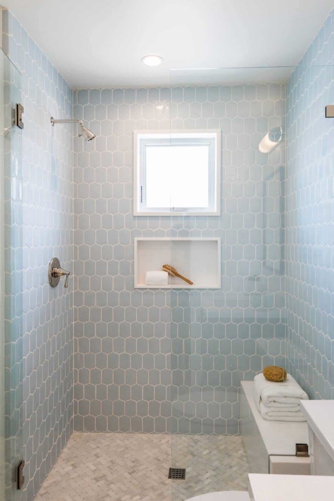 Small beach style bathroom, grey tile floor, blue tile walls
