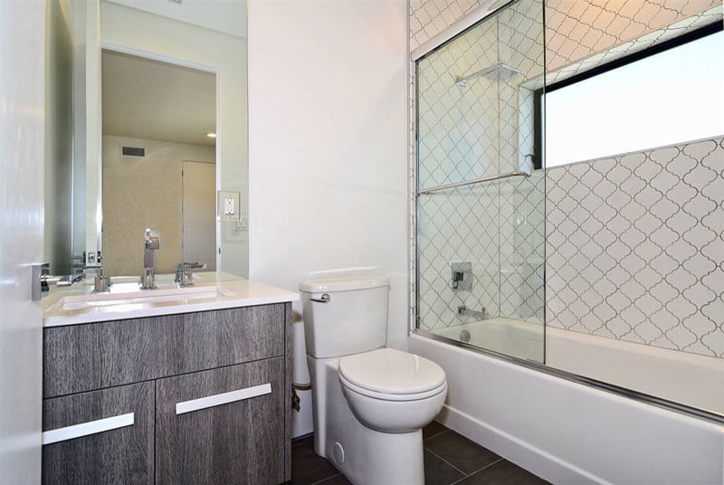 White tile walls, grey tile floor, grey cabinets