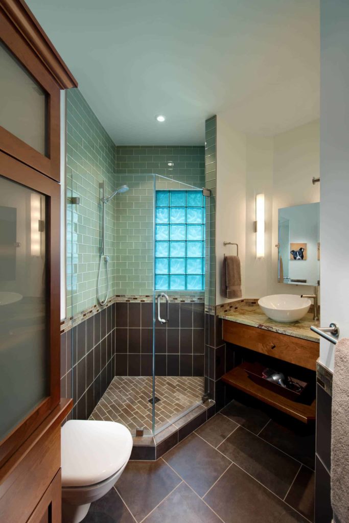 Small brown and blie corner shower, brown floor