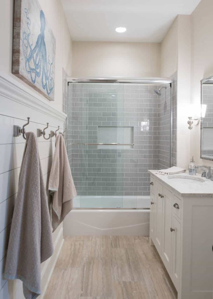 Beach style bathroom, grey tile walls, brown floor