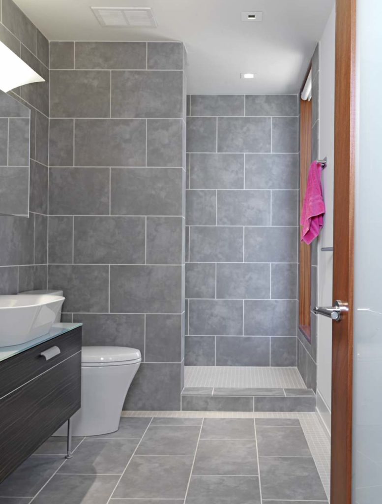 Small bathroom, large grey tile walls and floor