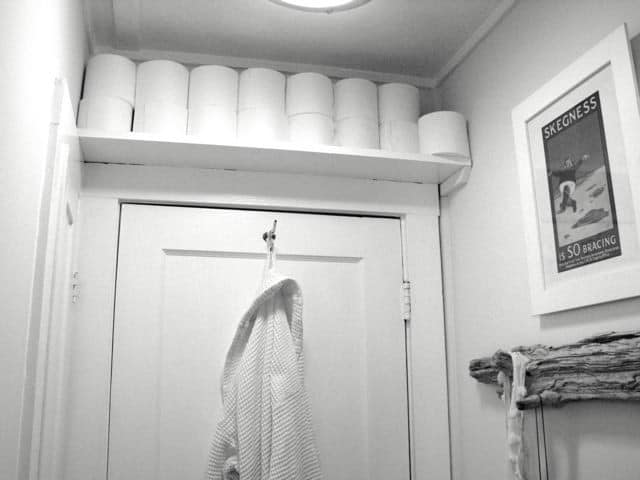 Frame the bathroom’s doorway with a shelf to hold toiletry items
