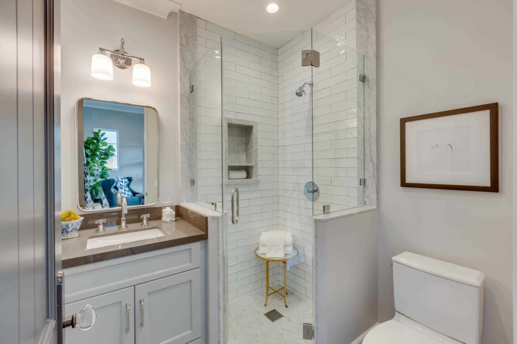Alcove shower, white walls and cabinets, white tile shower