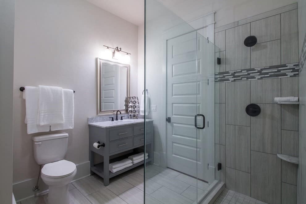 Corner shower, white walls, grey cabinets, grey tile shower