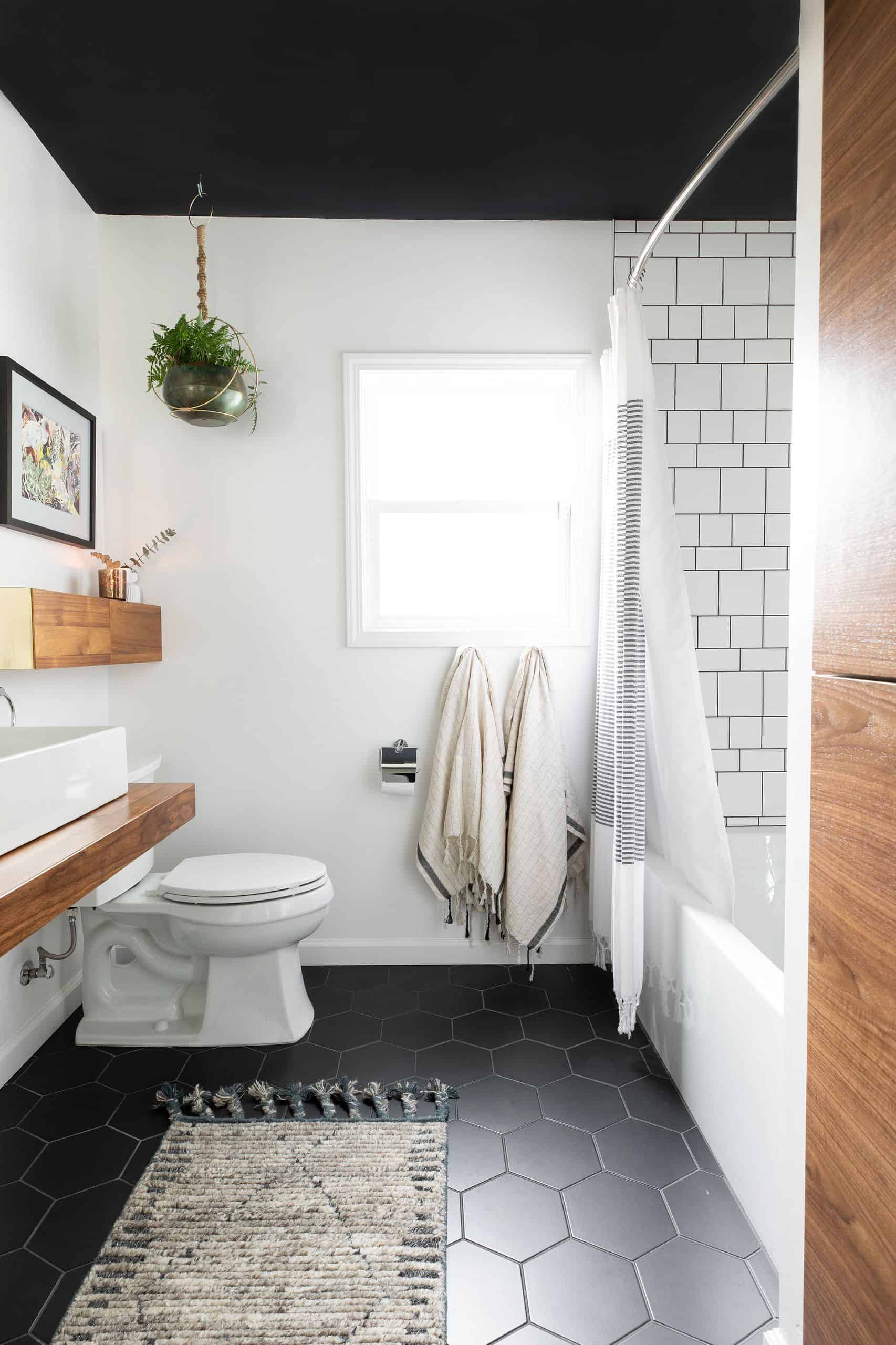 Blakc honey comb tile floor, white walls, wooden countertop