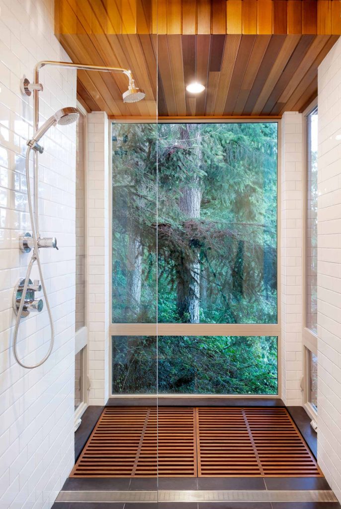 white tile multicolored floor corner shower design in New York