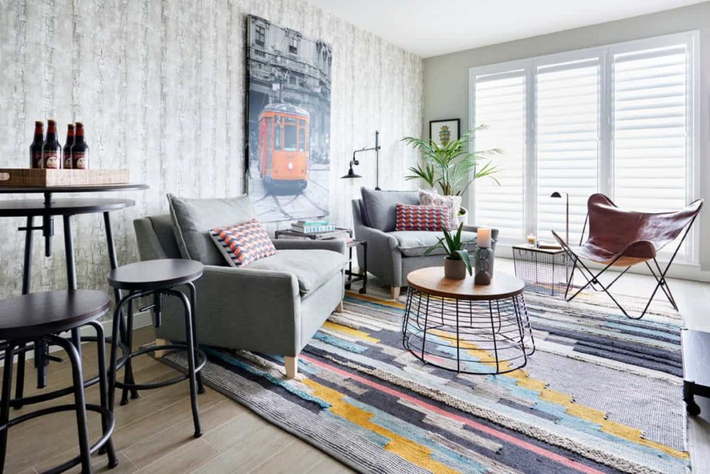 use of gray furniture, like these conversation chairs, helps to bring together the gray in the rest of the room