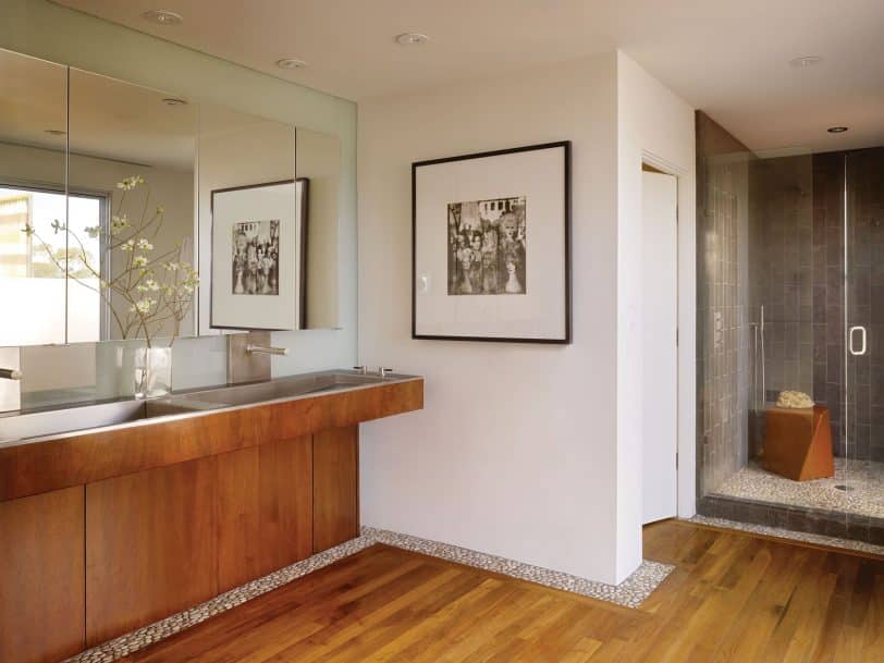 Inspiration for a large contemporary master medium tone wood floor alcove shower remodel in San Francisco with white walls, a trough sink, a hinged shower door, medium tone wood cabinets and stainless steel countertops
