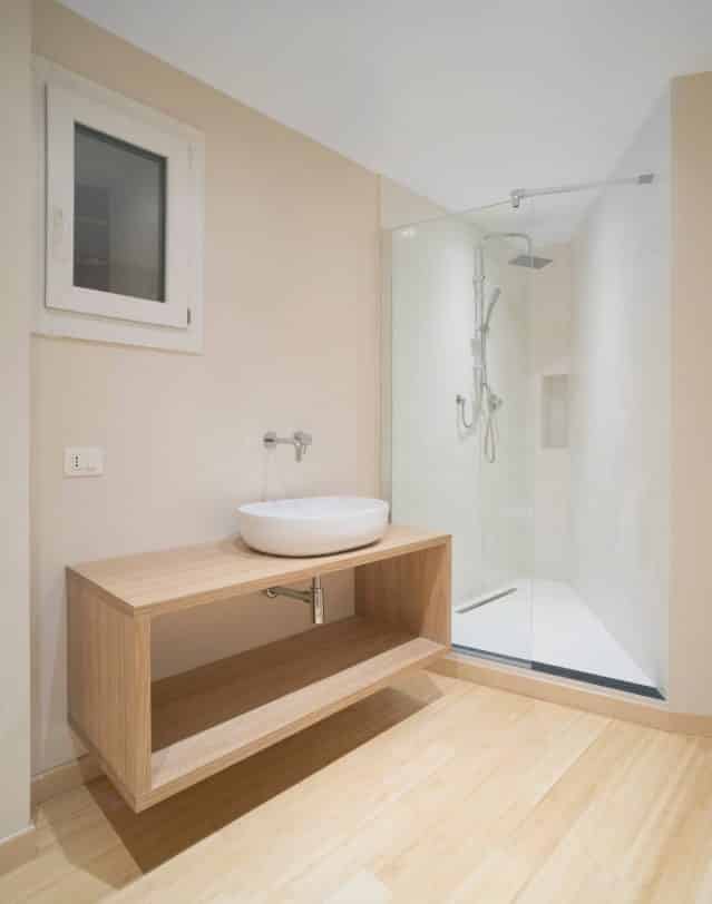 Small danish 3/4 white tile and porcelain tile bamboo floor and brown floor bathroom photo in Other with open cabinets, light wood cabinets, a two-piece toilet, beige walls, a vessel sink and wood countertops