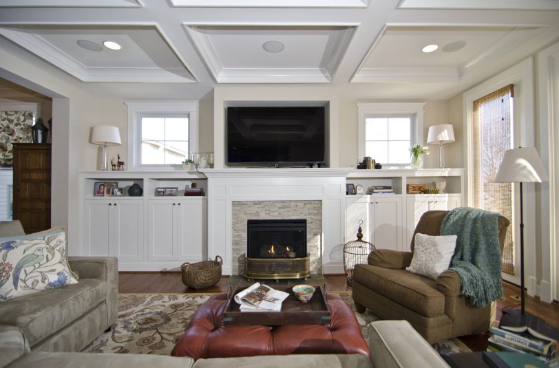 Example of a classic living room design in DC Metro with beige walls, a standard fireplace and a tile fireplace