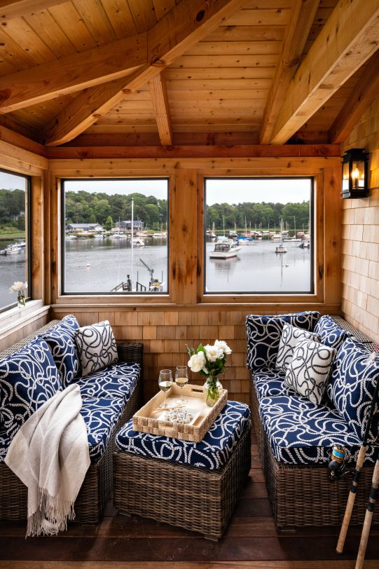 Small beach style screened-in porch idea in Boston with decking and a roof extension