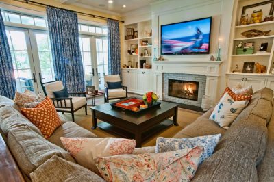 Example of a classic family room design in Los Angeles with yellow walls, a standard fireplace and a media wall, and a coffee table with a decorative tray
