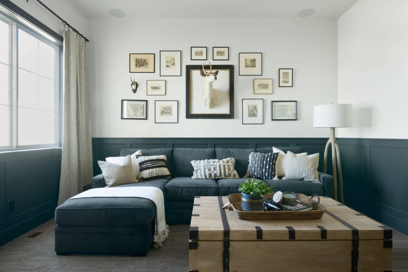 Example of a beach style enclosed carpeted and gray floor family room design in Boise with white walls